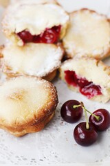Delicious cupcakes with cherry jam on the table 