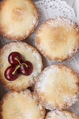 Delicious cupcakes with cherry jam on the table 