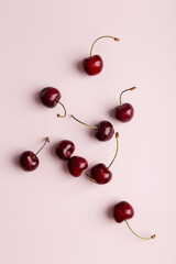 Fototapeta na wymiar sweet cherry at minimal pink background