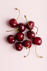 Obraz na płótnie Canvas Group of sweet cherry berries at flat pink background