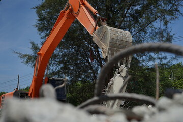 Hydraulic crusher excavator backoe machinery working on site demolition