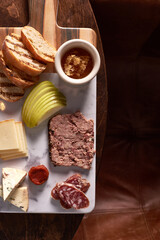 Charcuterie Meat and Cheese Plate on Marble and Wood