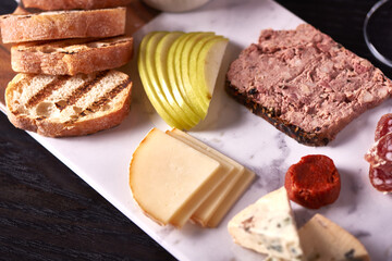 Charcuterie Meat and Cheese Plate on Marble and Wood
