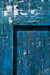 Texture of blue old boards with peeling paint.