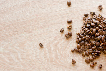 Closeup top view of many coffee beans in the ceramic mug with copy space for adding some text