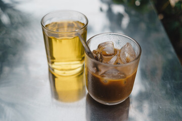 iced coffee with milk and hot tea in Vietnamese style on table. Selective Focus.