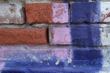 Close up peace of beautiful painted brick wall. Colorful brick wall texture and background.