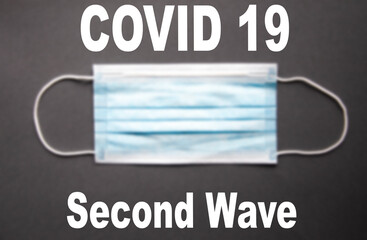 One blue medical masks lie on a gray background. Mast in open and closed state. Place for text.  Copy Space.  COVID-19