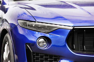 Obraz na płótnie Canvas Part of a blue luxury car. Car headlights. Luxury Headlights