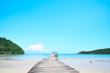 A wooden bridge stretching down to the sea, perfect for tourist photography