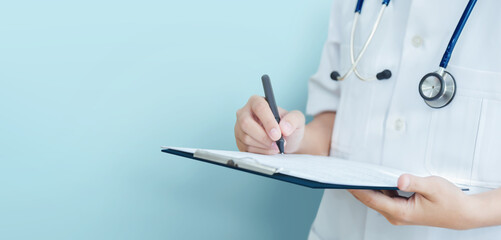 Asian female Doctor taking note information of patient in paperwork