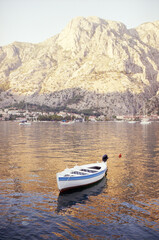 View of the fishing boat in the Bay of Kotor in Montenegro at sunset. Real grain scanned film.
