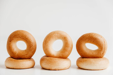Drying or mini round bagels on a white wooden background. Copy, empty space for text