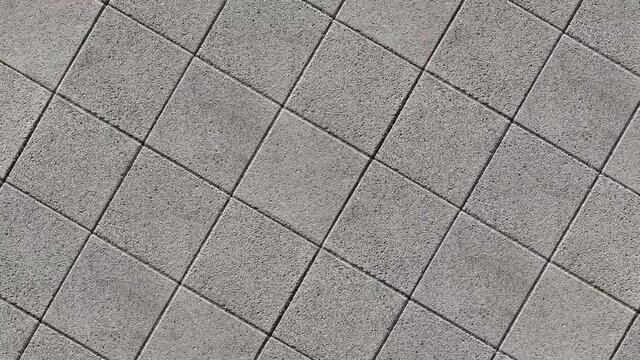 Landing on a square paved with square concrete paving slabs. The fall.