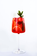 Lemonade made from oranges and mint. Soft drink in a tall glass on a white background. Copy of the space. An isolated object.