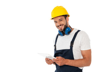 Fototapeta premium Handsome manual worker smiling at camera and holding digital tablet isolated on white