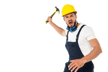 Angry workman in uniform and hardhat screaming while holding hammer isolated on white