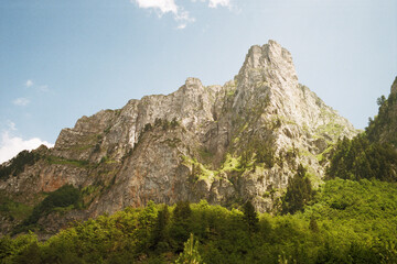 Fototapeta na wymiar Panoramic view of the mountains of the Prokletije National Park in Montenegro. Real grain scanned film.