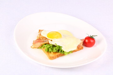 Fototapeta na wymiar Scrambled eggs with toasted bread and tomato