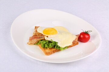 Fototapeta na wymiar Scrambled eggs with toasted bread and tomato