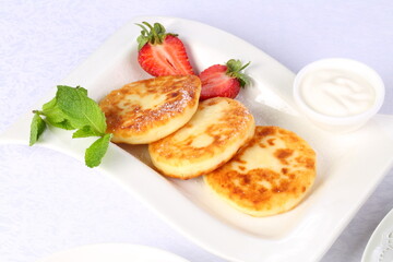 Cheesecakes with strawberries on white background