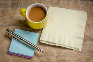 reminder note and napkin abstract, office or coffee break concept