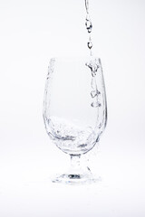 Fototapeta na wymiar Pour water in glass isolated on white background.