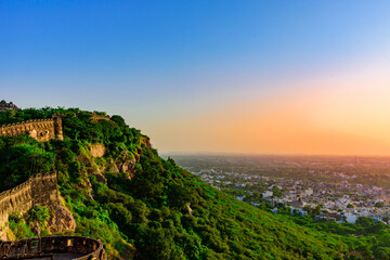 Obraz premium View during sunset from Chittor or Chittorgarh Fort with city in backdrop. It is one of the largest forts in India & listed in the UNESCO World Heritage Sites list as Hill Forts of Rajasthan.