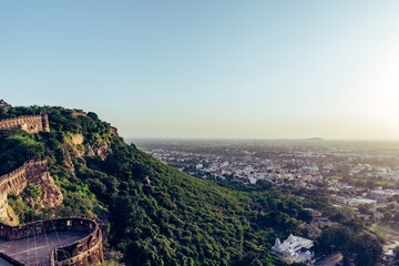 View during sunset from Chittor or Chittorgarh Fort with city in backdrop. It is one of the largest forts in India &  listed in the UNESCO World Heritage Sites list as Hill Forts of Rajasthan.