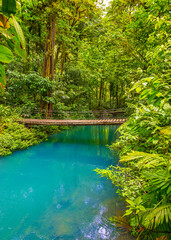 Rio Celeste with turquoise, blue water and small wooden bridge Tenorio national park Costa Rica. Central America.