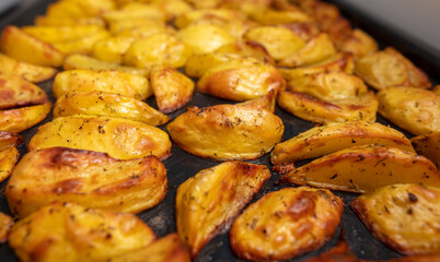 Baked potatoes in the oven as a background.