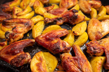 Baked chicken and potatoes in the oven as a background.