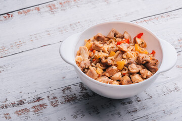 instant noodles with chicken and pepper with spicy sauce in a white bowl