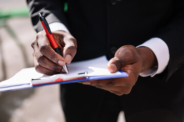 Business man signing a formal contract, white paper with pen, cl