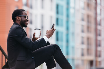 Profile of a happy guy using a camera in the phone, doing video