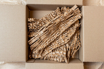 shredded, cut paper, carton for recycling inside a cardboard box. Ecology background.