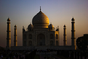 Agra, India - April 10,2014: Close up of Tajmahal, one of the seven wonder partially lit under dramatic sunrise