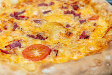 Homemade pizza with cheese and ham close up