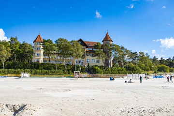historic hotel on the beach in Łeba in Poland on a sunny summer day - obrazy, fototapety, plakaty