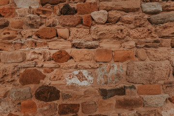 Stone wall texture/background,historical old ancient stone,preserved to our time, stones are laid evenly, solid construction has been standing for many centuries,ancient buildings,buildings and ruins