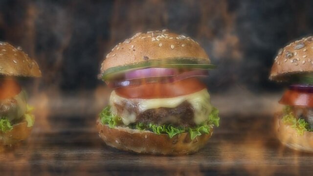 Hamburgers served on a rustic wooden surface surrounded by smoke and burning fire. 4K animation video