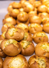 a lot of buns with different fillings and toppings are on the counter. High quality photo