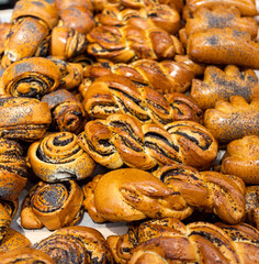 a lot of buns with different fillings and toppings are on the counter. High quality photo