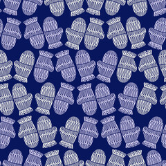 Seamless cute vector design of knitted mittens in pastel cold tones on blue