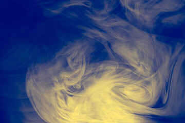Clouds of colored flowing smoke on a dark background.