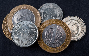 Turkish coins of various denominations on a dark background close-up - obrazy, fototapety, plakaty
