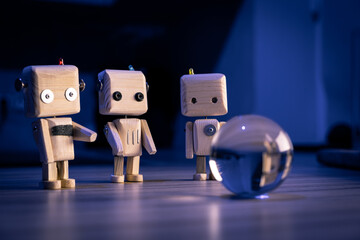 A small wooden toy robots looks at a glass ball in the dark. wallpaper, blured background. low light