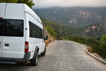 Fototapeta na wymiar Tourist minibus on mountains road