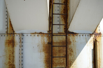 An old rusted silo photographed in a port area in summer