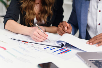 Asian Business woman Manager checking and signing applicant filling documents reports papers...